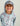 Child wearing light blue and mauve camouflage hoodie with white KC logo and metal badge on hood.