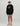 Child wearing black Huk hoodie with tan logo and gray shorts.