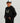 Black cotton fleece hoodie with camo-patterned HUK logo and front pouch pocket on child.