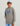 Child wearing gray Huk hoodie with blue logo and front pocket.