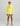 Child wearing bright yellow Huk hoodie with gray logo and gray shorts, paired with a white Huk cap.