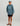 Child wearing slate blue Huk hoodie with logo, black shorts, and sandals.