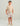 Boy wearing beige t-shirt and multicolor floral swim shorts with elastic waistband and drawstring.