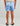 Child wearing blue and white tie-dye swim shorts with elastic waistband, back view.