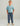 Child wearing light blue t-shirt and dark blue cargo joggers with side pockets and drawstring waist.
