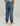 Child wearing slate blue cargo joggers with side pockets and elastic cuffs, paired with tan and white sneakers.