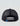 Black foam trucker hat with mesh back panels, adjustable snap closure, and blue logo patch.