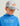 Child wearing white and gray camo trucker hat with mesh back panel and orange Huk logo patch.