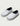 Pair of white Huk clogs with dark gray trim, black heel cup, and navy blue insole lining.