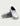 White clog with black trim and Huk branding, shown from front and bottom sole view with geometric tread pattern.